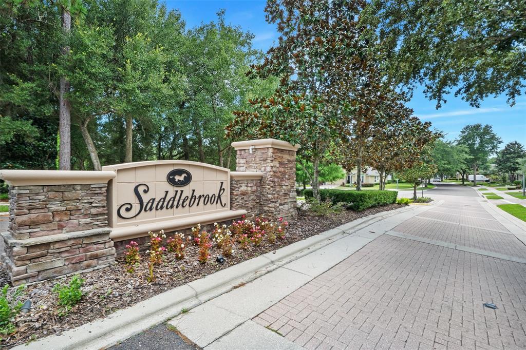 A stone and stucco monument sign marks the entrance to the Saddlebrook neighborhood — 740 PREAKNESS CIRCLE, DELAND, FL