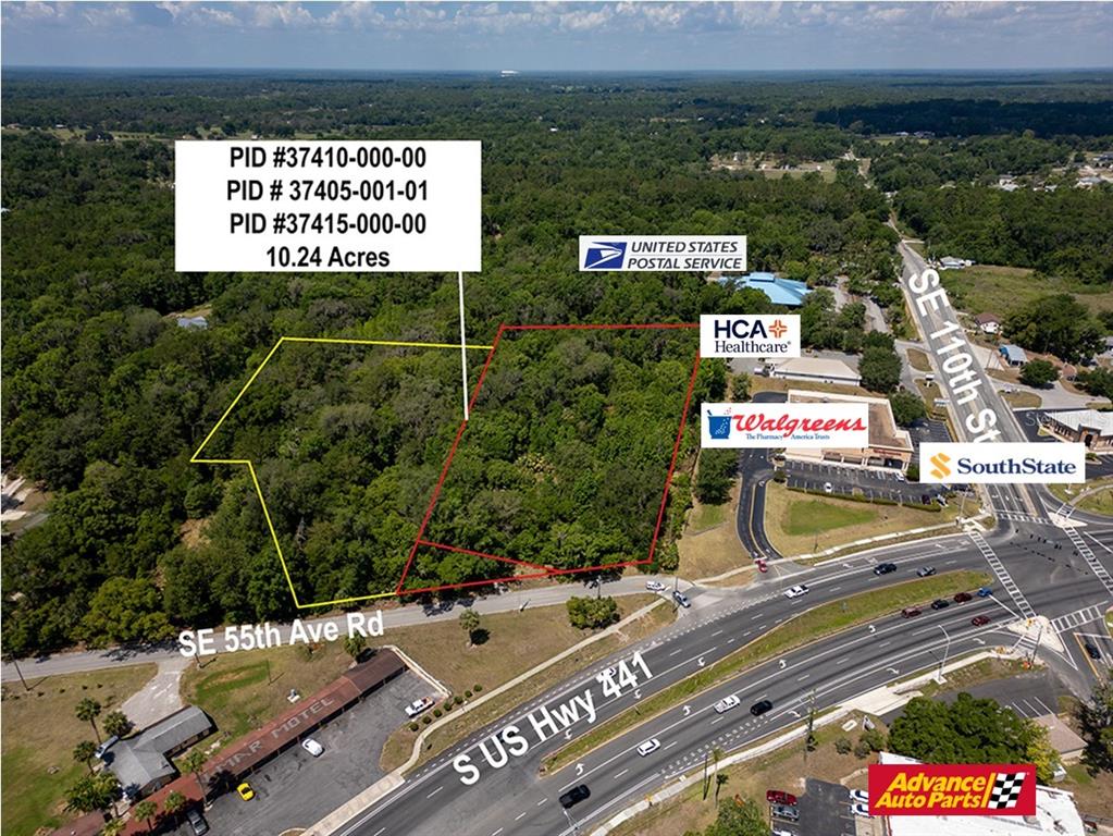 An aerial view shows a wooded 10.24-acre plot of land adjacent to commercial businesses and roads — 11090 SE 55TH AVENUE ROAD, BELLEVIEW, FL