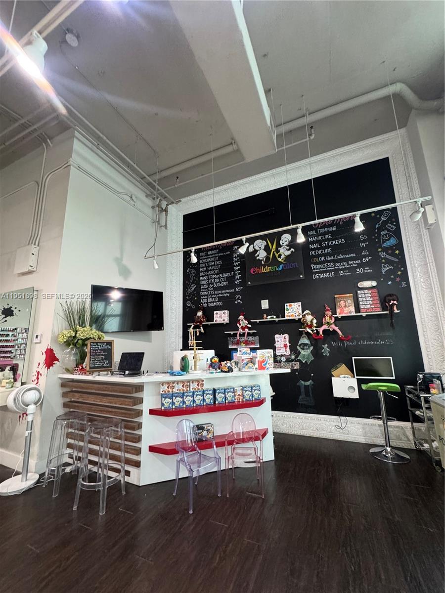 A children's salon features a reception desk, a chalkboard menu, and clear plastic chairs — 000 NE Confidential, Miami FL 33137, MIAMI, FL