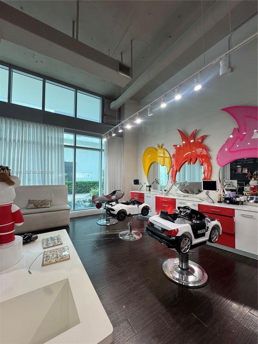 A children's hair salon features car-shaped styling chairs, colorful wall mirrors, and large windows — 000 NE Confidential, Miami FL 33137, MIAMI, FL