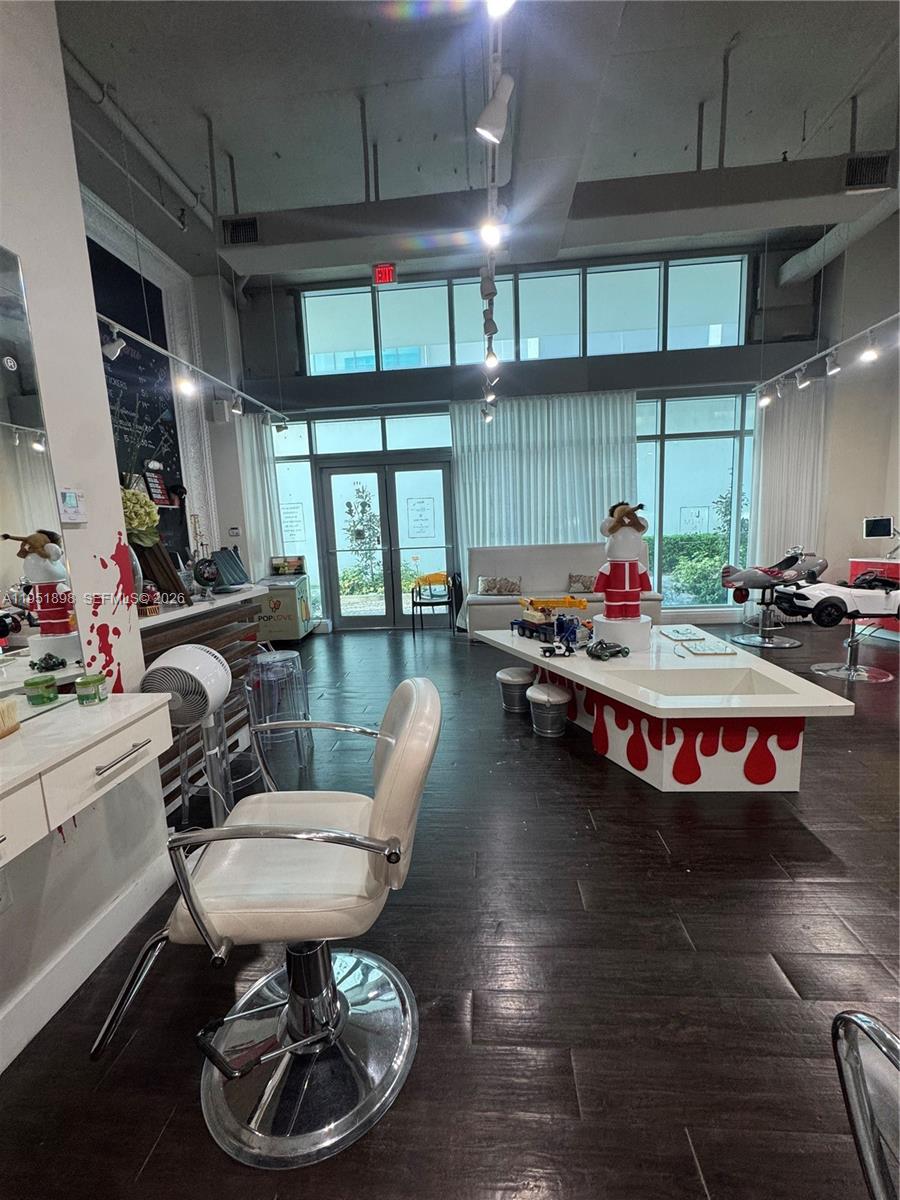 A children's hair salon features styling chairs, car-shaped seats, and a central table with toys — 000 NE Confidential, Miami FL 33137, MIAMI, FL