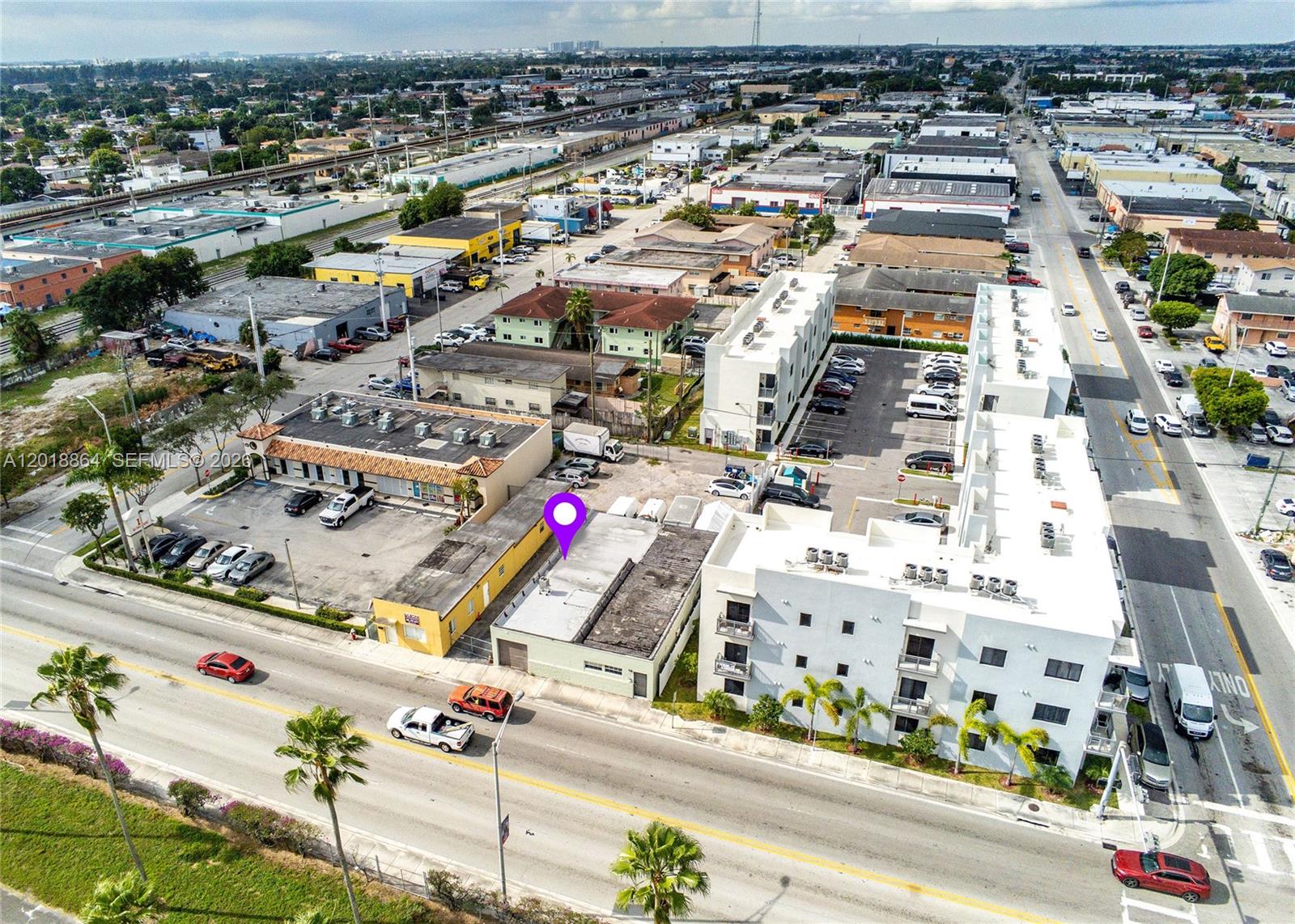 An aerial view shows a commercial building with a purple location pin on its roof — 2230 Palm Ave, Hialeah FL 33010, HIALEAH, FL