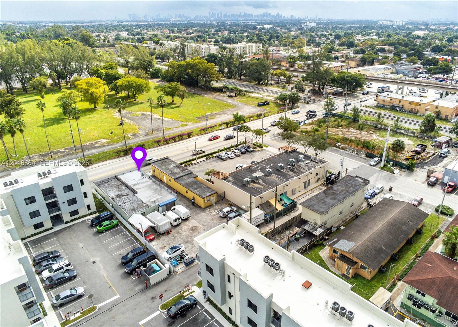 An aerial view shows commercial buildings, parking lots, and a nearby road with city traffic — 2230 Palm Ave, Hialeah FL 33010, HIALEAH, FL