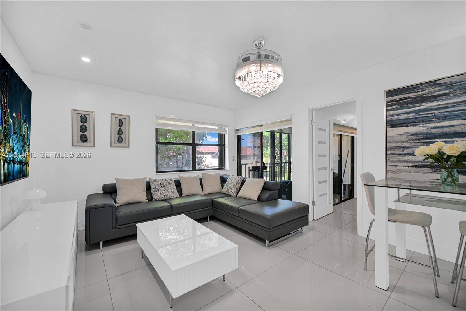 A living room features a dark sectional sofa, white coffee table, and a crystal ceiling fan — 6535 W 26th Dr # 39, Hialeah FL 33016, HIALEAH, FL