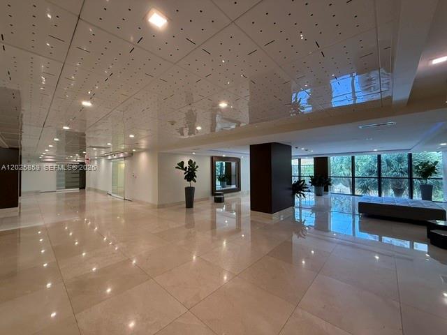 A modern, spacious lobby features polished tile floors, a reflective ceiling, and floor-to-ceiling windows — 540 Brickell Key Dr # 1024, Miami FL 33131, MIAMI, FL