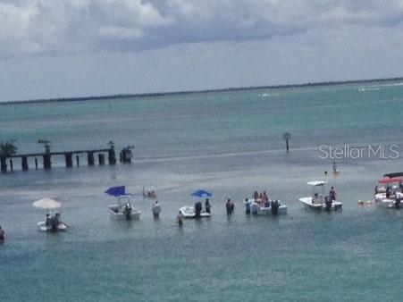 A view of a shallow bay with several small boats and people wading in the water — 4075 GILLOT BOULEVARD, PORT CHARLOTTE, FL