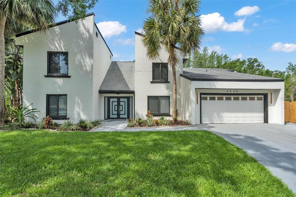 A screened-in patio features a swimming pool, outdoor kitchen, and wicker seating area — 4520 PINE HOLLOW DRIVE, TAMPA, FL