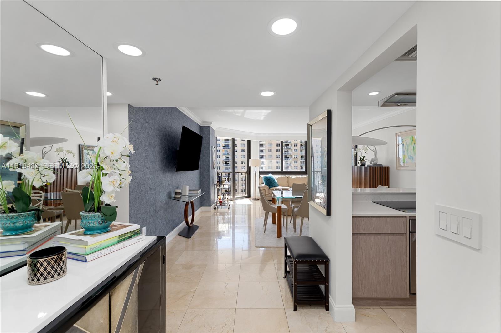 A view from an entryway into a living and dining area with marble floors — 520 Brickell Key Dr # A1207, Miami FL 33131, MIAMI, FL
