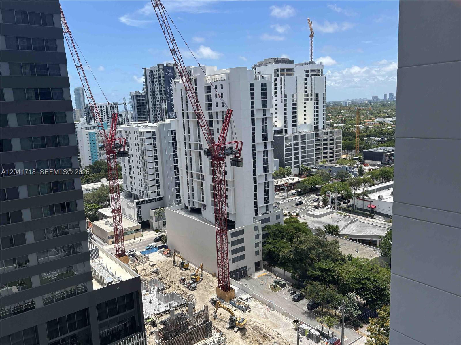 An elevated view shows a construction site with two red cranes and several high-rise buildings — 690 SW 1st Ct # 2124, Miami FL 33130, MIAMI, FL