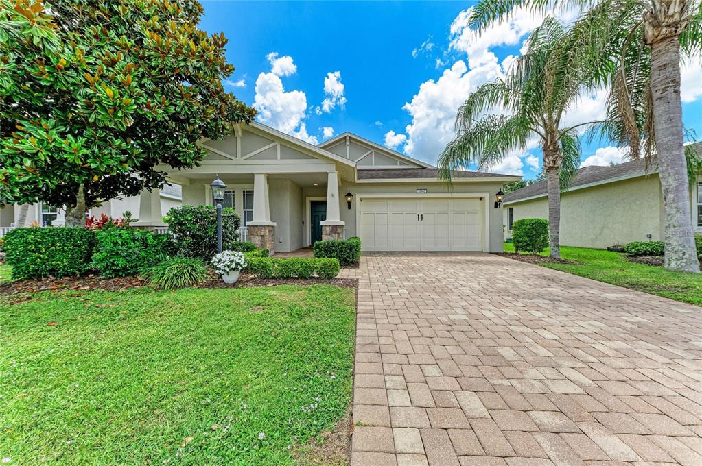 A single-story house with a paved driveway, a two-car garage, and a front porch — 11960 FOREST PARK CIRCLE, BRADENTON, FL