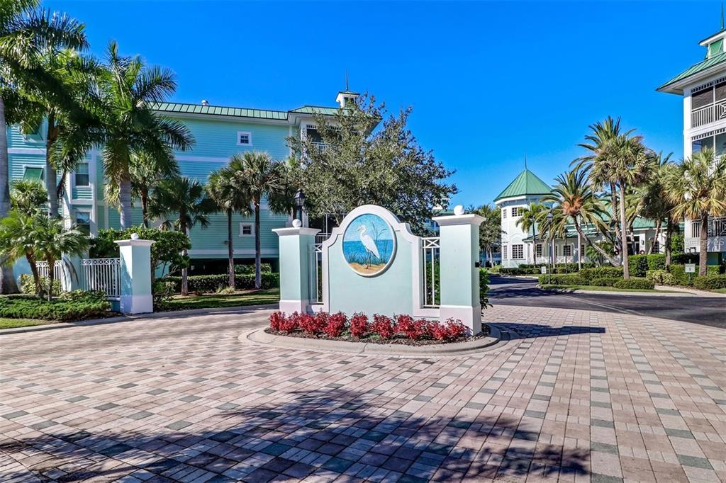 A paved walkway leads to a picnic table and a covered grill in a park area — 5123 MELBOURNE STREET UNIT D106, PORT CHARLOTTE, FL