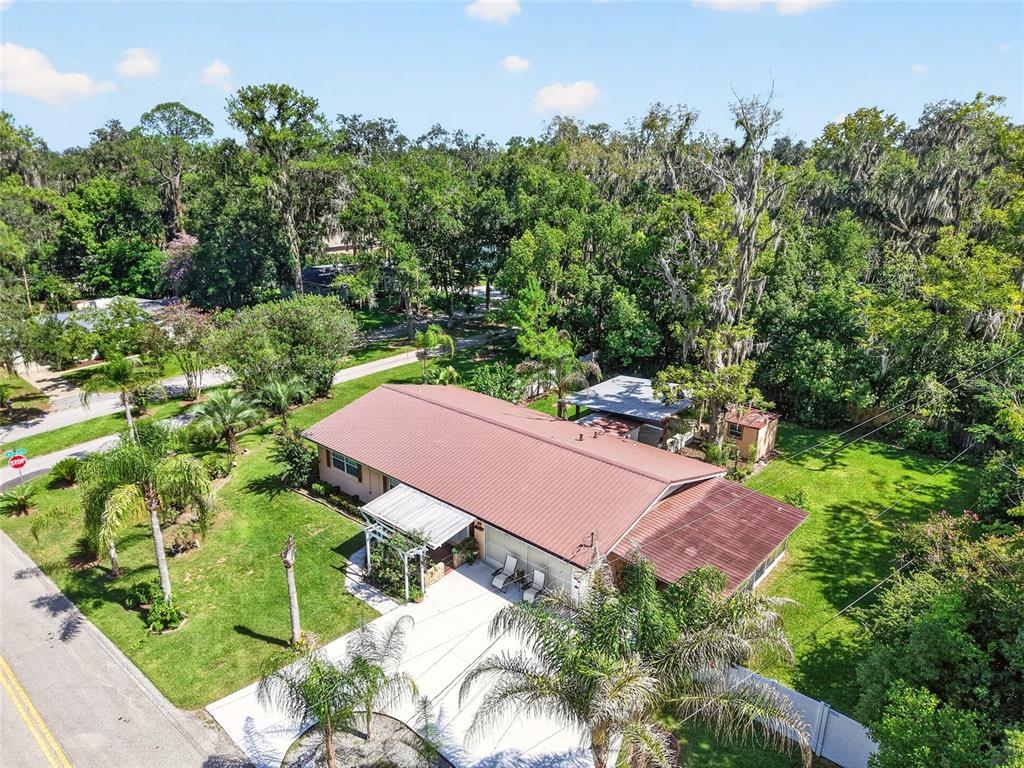 An aerial view of a single-story house with a metal roof and a concrete driveway — 2840 SE 2ND STREET, OCALA, FL