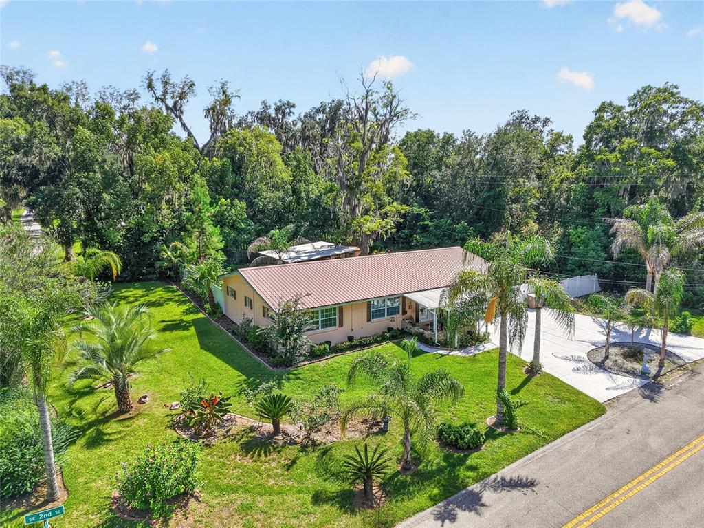 An aerial view of a single-story house with a metal roof and a large lawn — 2840 SE 2ND STREET, OCALA, FL