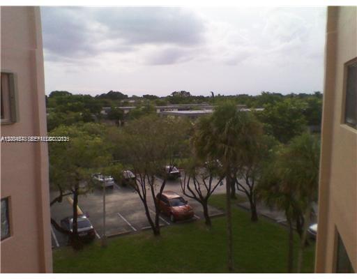 An elevated view of a parking lot surrounded by trees and residential buildings — 8600 SW 133rd Ave Rd # 413, Miami FL 33183, MIAMI, FL
