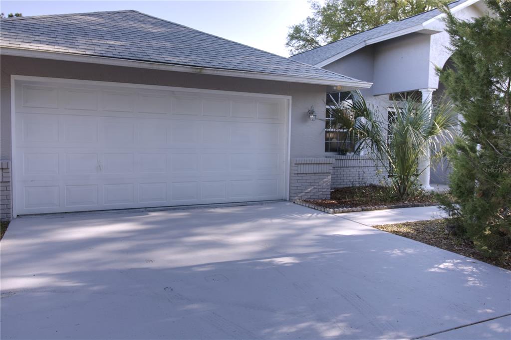 A covered entryway with white columns leads to the front door of a suburban home — 2 SEAGIRT COURT, PALM COAST, FL