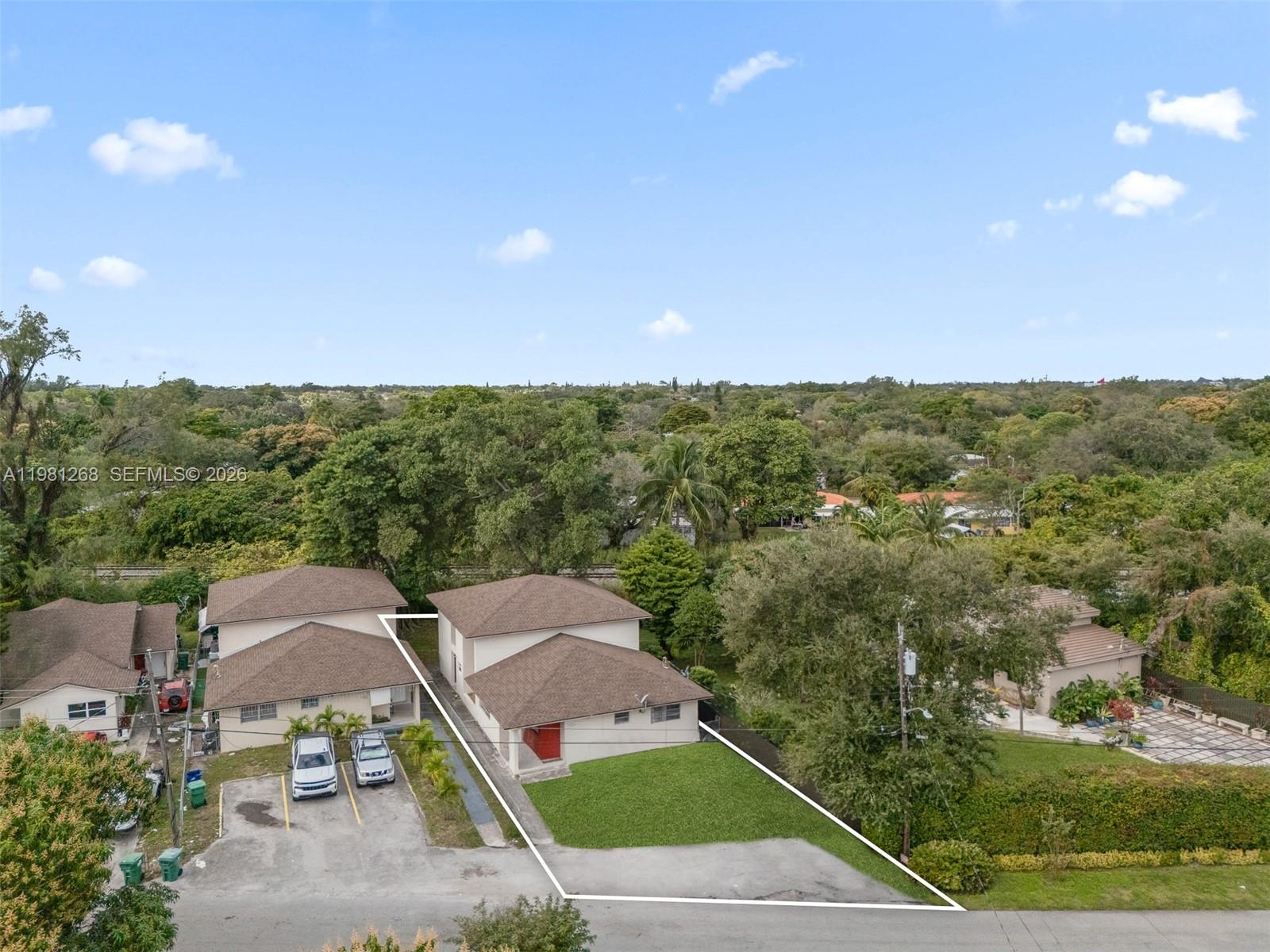 An aerial view shows two adjacent residential buildings with brown roofs and paved parking areas — 11330 Peachtree Dr, Miami FL 33161, MIAMI, FL