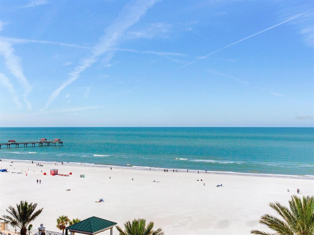 A view of a sandy beach, the ocean, and a pier under a clear sky — 11 SAN MARCO STREET UNIT 807, CLEARWATER BEACH, FL
