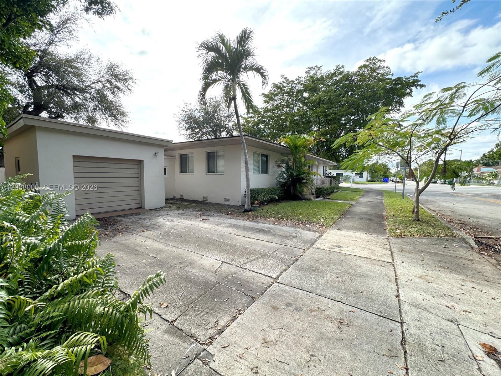 A single-story house with a garage, concrete driveway, and palm tree in the front yard — 4 NE 47th St, Miami FL 33137, MIAMI, FL