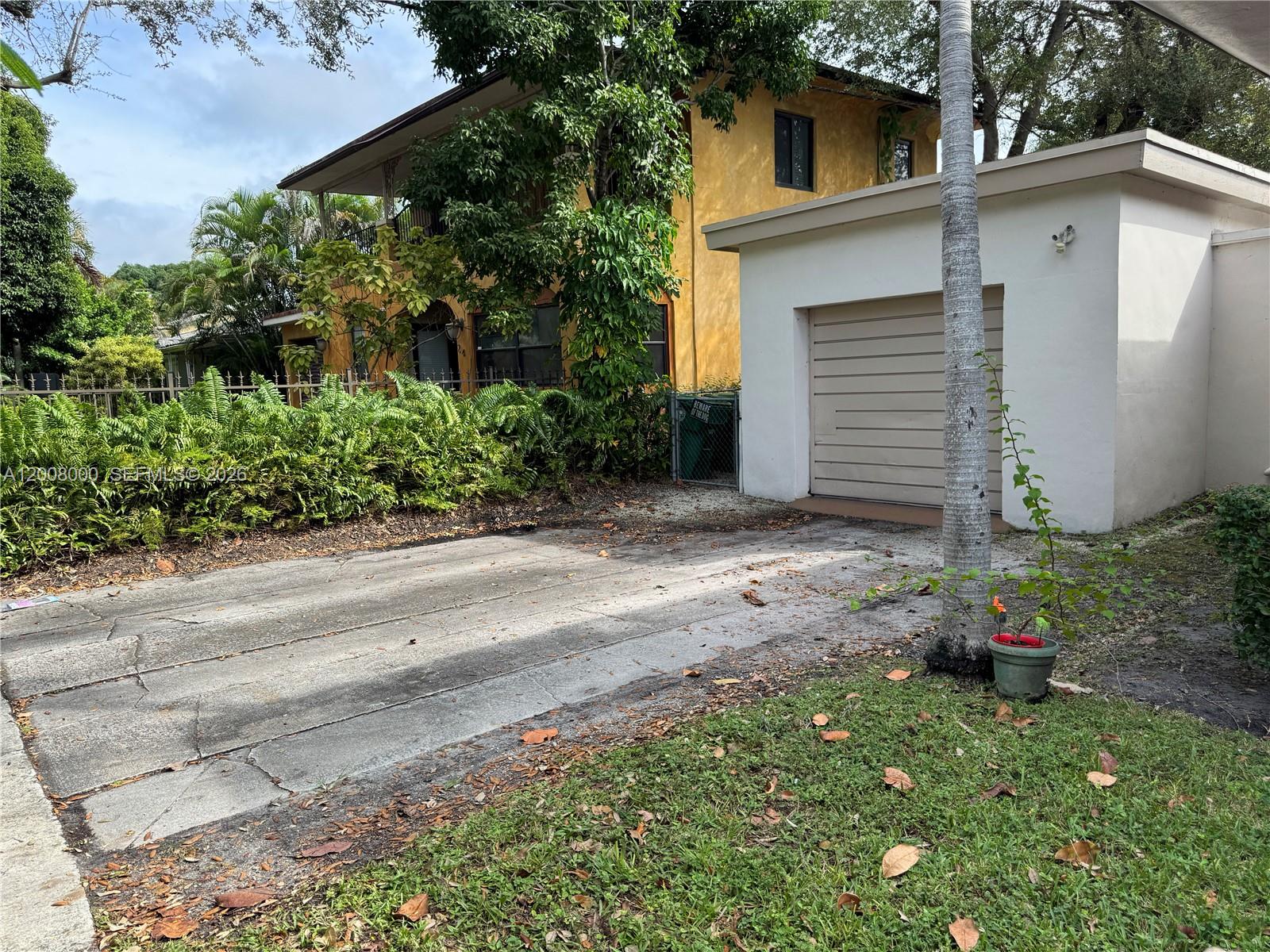 A two-story yellow house with a detached white garage and a concrete driveway — 4 NE 47th St, Miami FL 33137, MIAMI, FL
