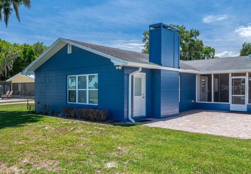 A wooden dock extends into a lake in front of a grassy yard and houses — 10742 W BEACH PARKWAY, LAKE WALES, FL