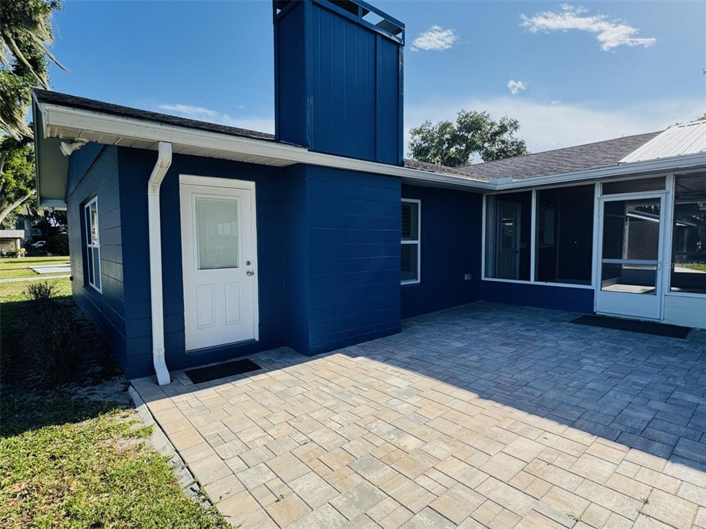 A covered porch features blue vertical siding, a wood-paneled ceiling, and a ceiling fan — 10742 W BEACH PARKWAY, LAKE WALES, FL