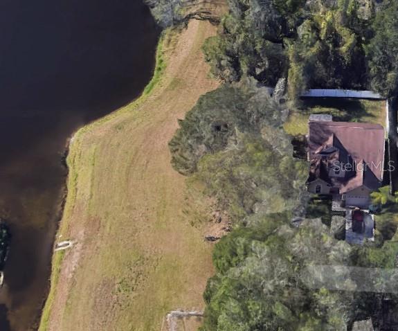 An aerial view shows a house with a large yard bordering a body of water — 1518 SALEM DRIVE, ORLANDO, FL