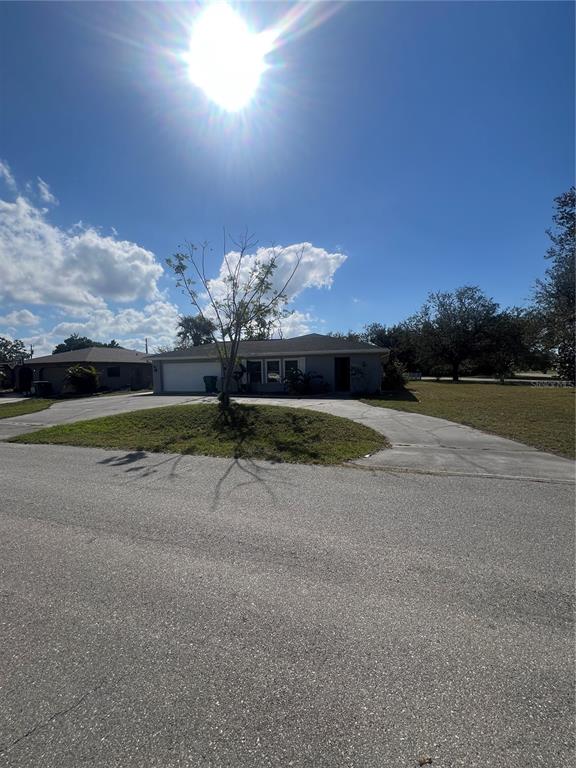 A single-story house with a two-car garage and a large circular driveway — 22065 MALONE AVENUE, PORT CHARLOTTE, FL