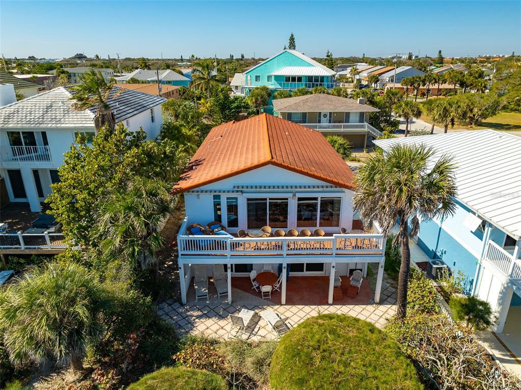 An aerial view of a two-story house with a terracotta roof and a wooden deck — 8108 PRESIDENTIAL COURT, CAPE CANAVERAL, FL