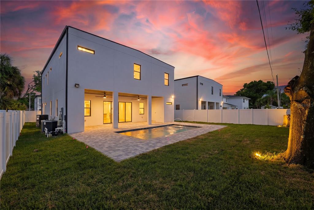 The rear exterior of a modern two-story house features a covered patio and swimming pool — 2308 1/2 N ELCOE DRIVE, TAMPA, FL