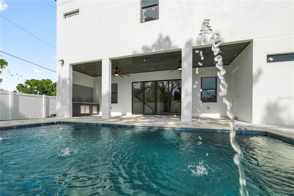 A modern white house features a covered patio with an outdoor kitchen and a pool — 2308 1/2 N ELCOE DRIVE, TAMPA, FL