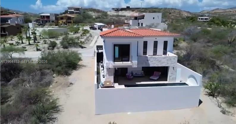 An aerial view of a two-story white house with a tiled roof and private pool — 25 Paséo Vista Hermosa, VA 23405, VA
