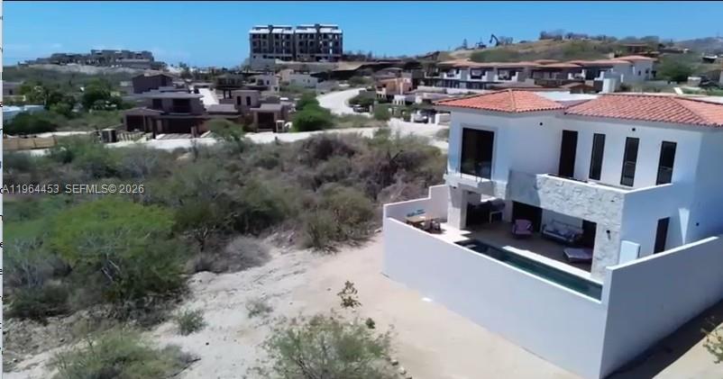 An aerial view shows a modern white house with a pool and tile roof — 25 Paséo Vista Hermosa, VA 23405, VA