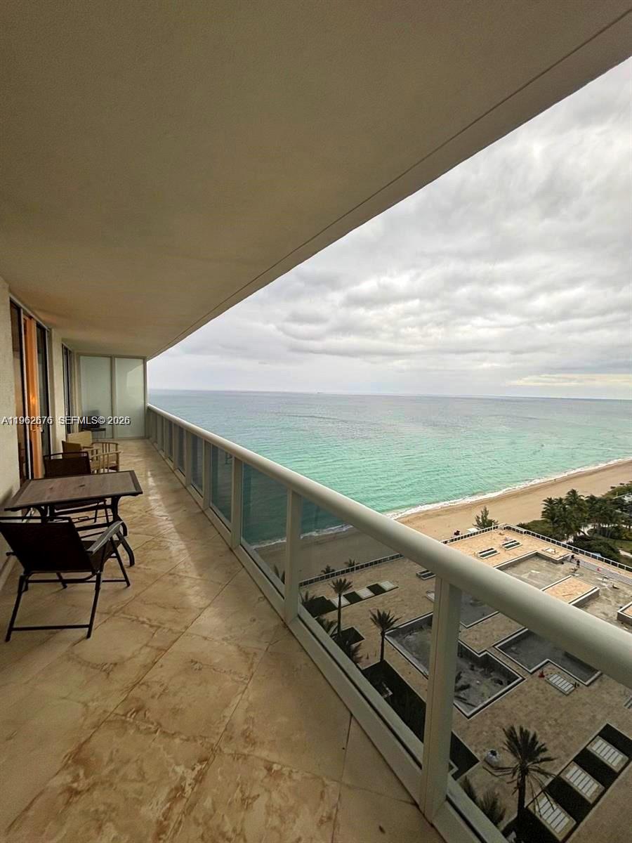 A balcony with tile flooring overlooks the ocean and beach below — 1830 S OCEAN DR # 2004, Hallandale Beach FL 33009, HALLANDALE BEACH, FL