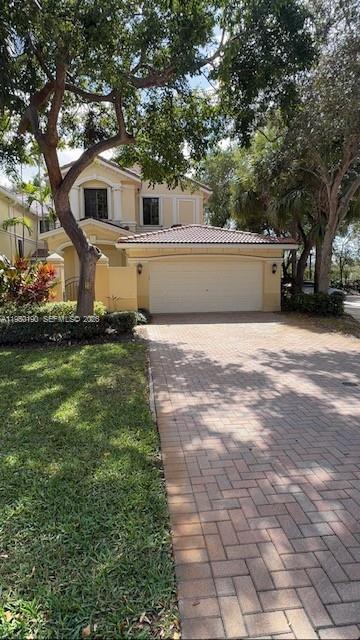 The exterior entrance features a paved courtyard, double doors, and two large white columns — 1659 Passion Vine Cir # 4, Weston FL 33326, WESTON, FL