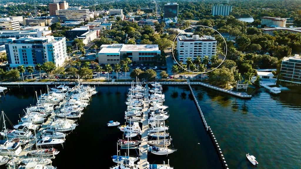 An aerial view shows a marina with many boats docked in front of city buildings — 1400 1ST AVENUE W UNIT 806, BRADENTON, FL