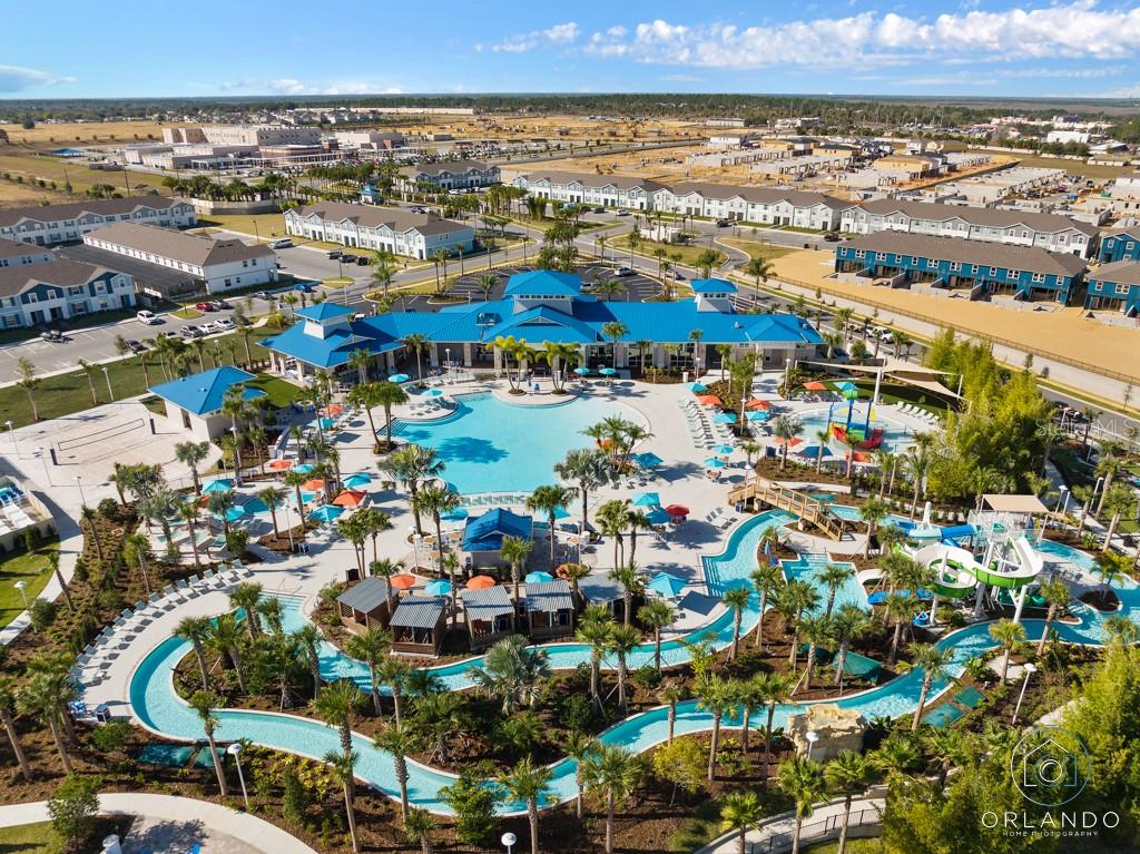 An aerial view of a community swimming pool complex with a lazy river and clubhouse — 3723 LANA AVENUE, DAVENPORT, FL