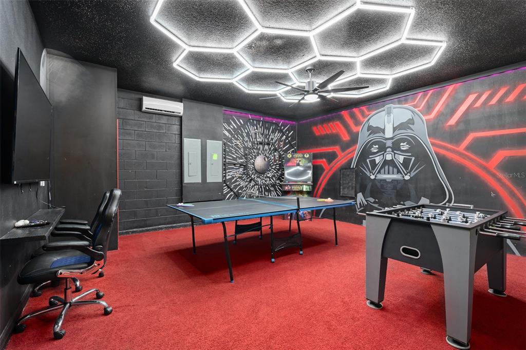 A game room features a ping pong table, foosball table, Star Wars mural, and hexagonal lighting — 3723 LANA AVENUE, DAVENPORT, FL