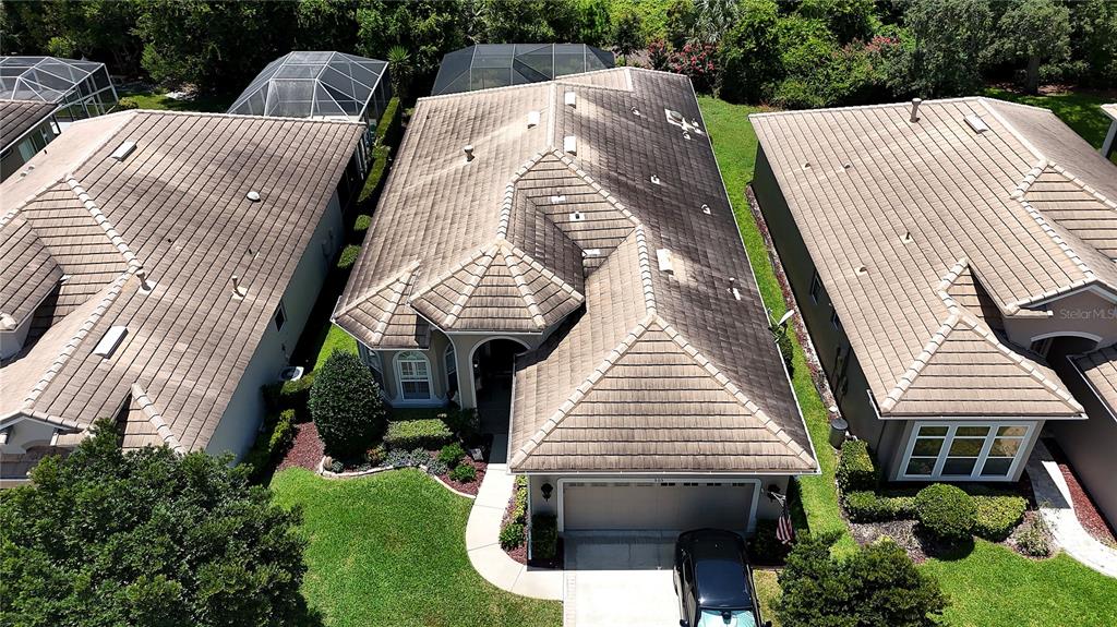 A beige stucco house features a dark front door, arched entryway, and landscaped front yard — 505 SOTHEBY WAY, DEBARY, FL