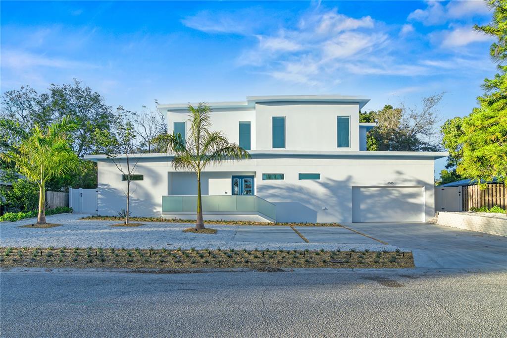 A modern two-story white house features a flat roof, glass balcony, and attached garage — 2585 CLEMATIS STREET, SARASOTA, FL