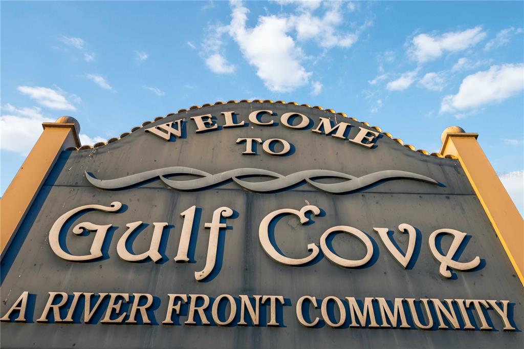 A sign for the Gulf Cove community stands against a blue sky with clouds — 4179 SPIRE STREET, PORT CHARLOTTE, FL