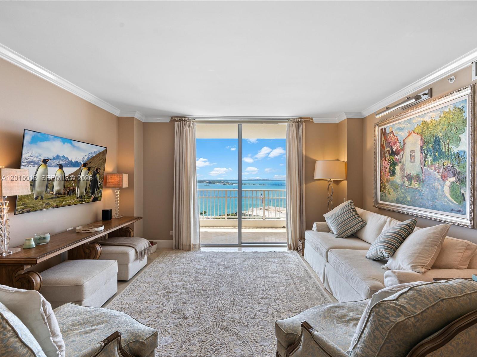 A living room features a television, a sofa, and a balcony overlooking the ocean — 701 Brickell Key Blvd # 2511, Miami FL 33131, MIAMI, FL
