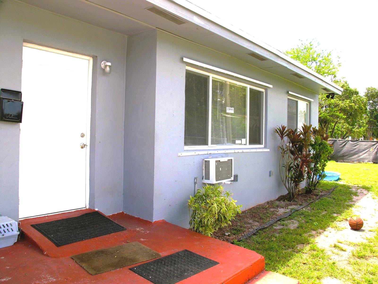A light blue house exterior features a white front door, windows, and a red porch — 340 NW 6th Street # 2, Pompano Beach FL 33060, POMPANO BEACH, FL