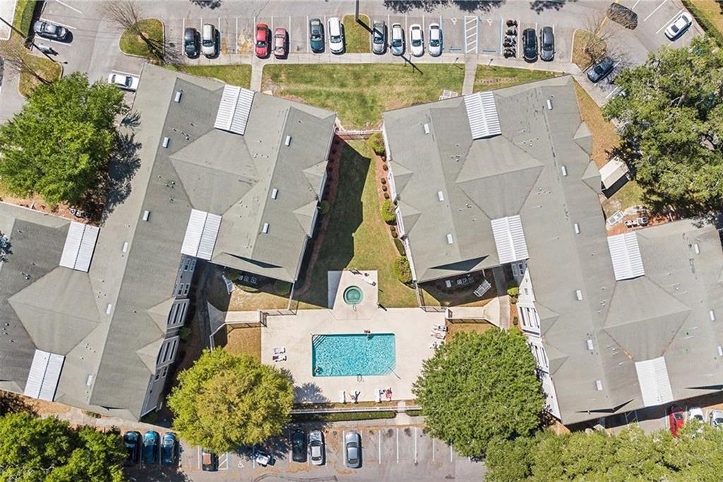 Aerial view of two apartment buildings surrounding a central swimming pool and parking lot — 4000 SW 23RD STREET UNIT 5-106, GAINESVILLE, FL