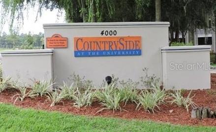 A beige monument sign for Countryside at the University stands in a landscaped garden bed — 4000 SW 23RD STREET UNIT 5-106, GAINESVILLE, FL