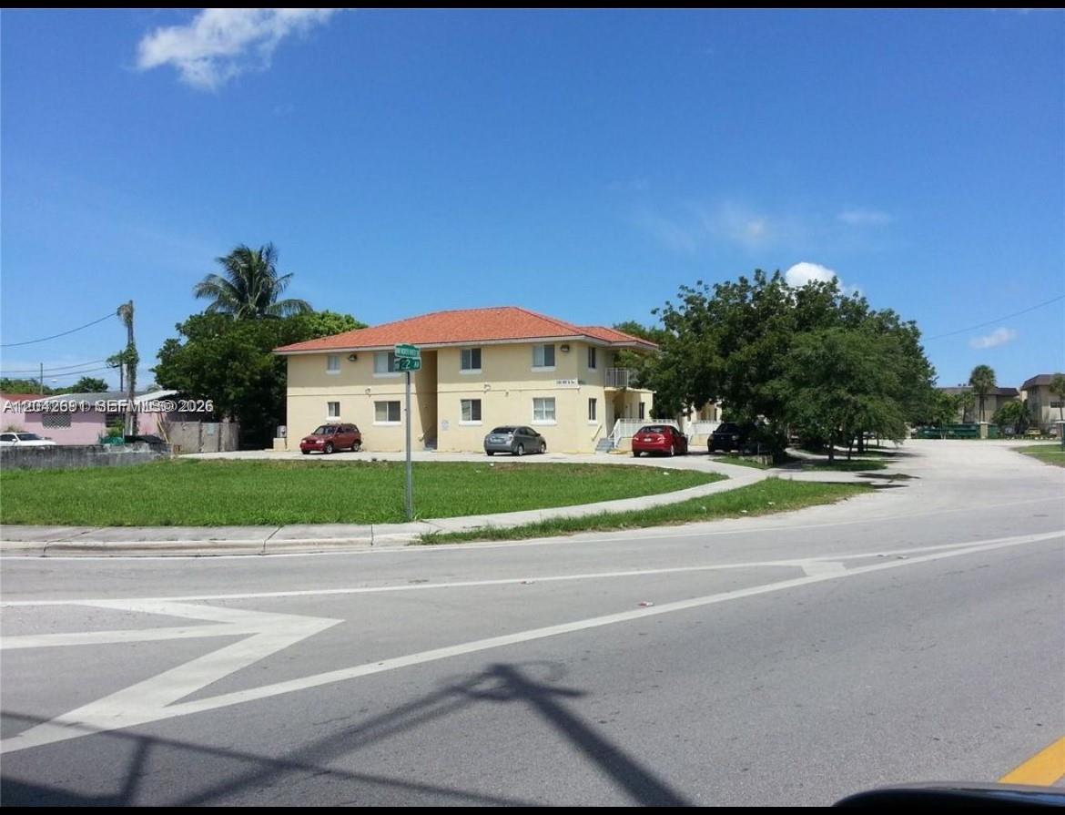 A two-story, light yellow apartment building sits on a corner lot with a grassy lawn — 2185 NW 16th Ter # 10, Miami FL 33125, MIAMI, FL