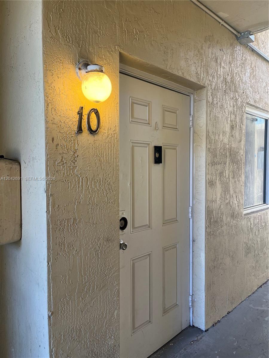 An exterior view shows a beige door marked with the number 10 and a light — 2185 NW 16th Ter # 10, Miami FL 33125, MIAMI, FL