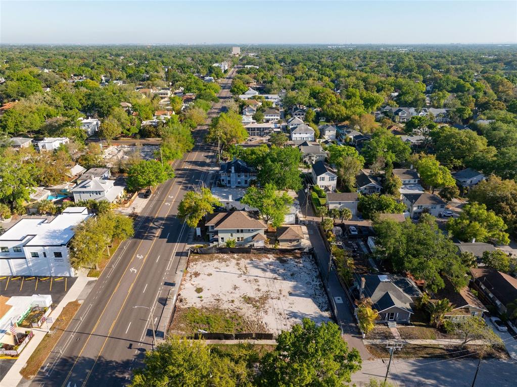 An aerial view shows a vacant lot situated between a road and residential houses — 1201 DR MARTIN LUTHER KING JR STREET N, ST PETERSBURG, FL