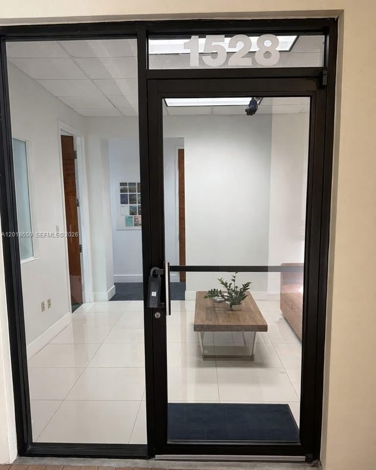 A glass-paneled office door with the number 1528 above it opens into a waiting area — 1528 Weston Rd, Weston FL 33326, WESTON, FL