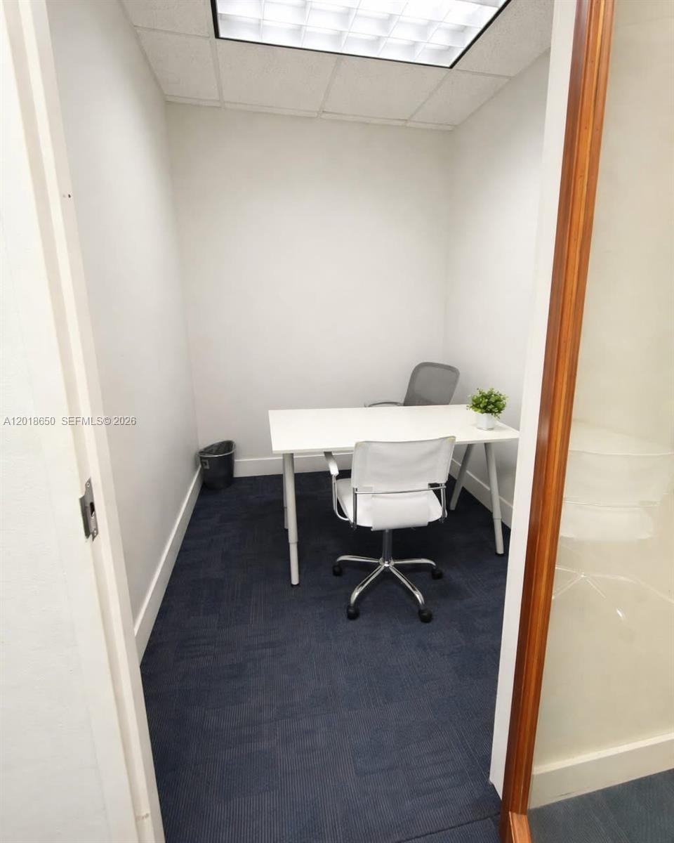 A small office features a white desk, two chairs, and dark blue carpeting — 1528 Weston Rd, Weston FL 33326, WESTON, FL