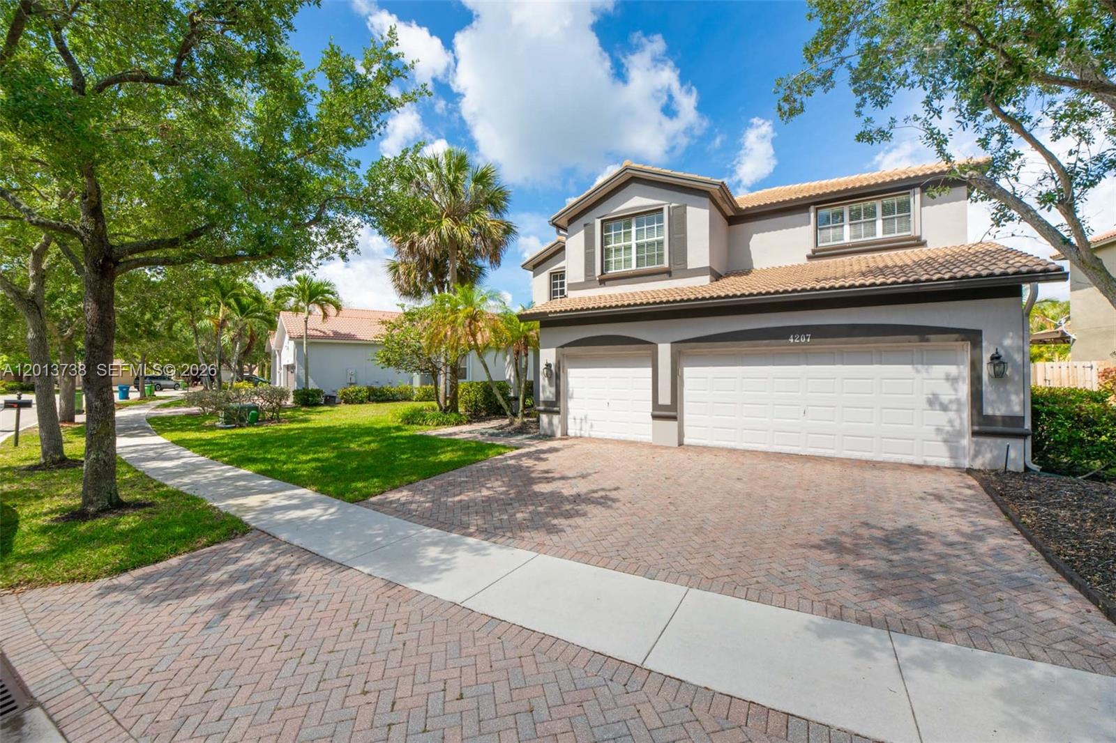 A two-story house with a brick paver driveway and a three-car garage — 4207 W Whitewater Ave, Weston FL 33332, WESTON, FL
